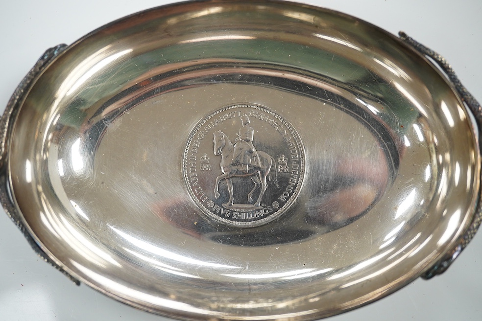 A 1970's Brittania standard silver commemorative small dish, C. Hoare & Co, London, 1972, 92mm, together with a German 925 oval dish with serpent handles and inset with coin, gross 8.9oz. Condition - fair